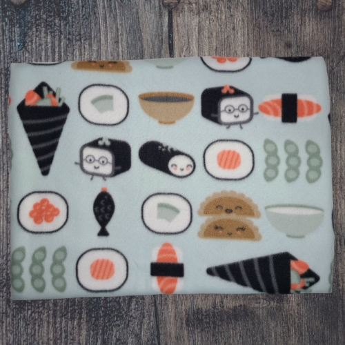 Self-heating pet bed, pale mint green background with various black, white, salmon colored sushi rolls, some with faces.